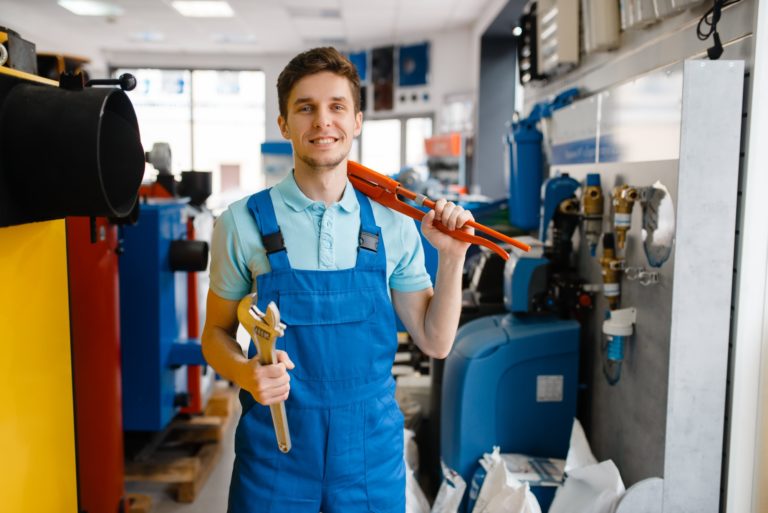 plumber-shows-pipe-wrenches-in-plumbering-store.jpg